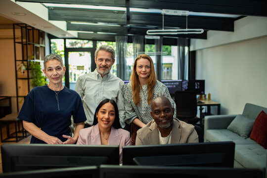 Diverse team of colleagues at modern office workstations
