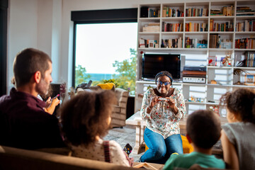 Fototapeta premium Family playing party games in cozy living room