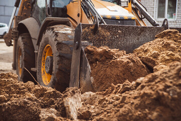 A picture of a tractor pushing a pile of earth forward into the frame. Perfect place to insert text © Rystemys
