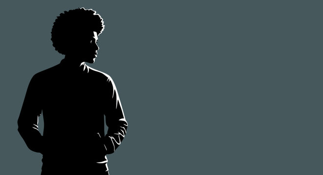 Silhouette of a young man with afro hairstyle looking thoughtfully into the distance