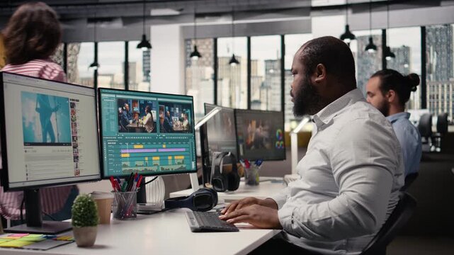 Portrait of african american man working on film montage editing, applying color grading and cutting raw clips for cinematic footage creation. Film engineer makes adjustments in post production.