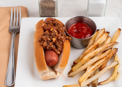 hot dog top with sloppy joe and a side of french fries