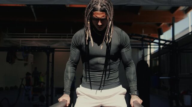 Male Athlete Performing Dips In The Gym
