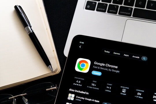 Google Chrome logo on iPad in Apple Liquid Glass iOS 26 interface photographed on desk with pen and laptop. Stafford, United Kingdom, April 13, 2026.