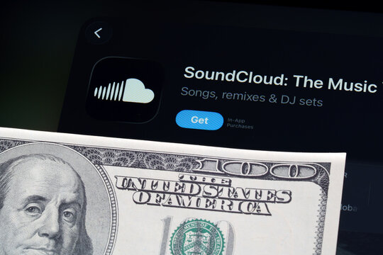 SoundCloud listing on iPad highlights Apple Liquid Glass interface and iOS 26 update with dollar bill foreground. Stafford, United Kingdom, April 13, 2026.