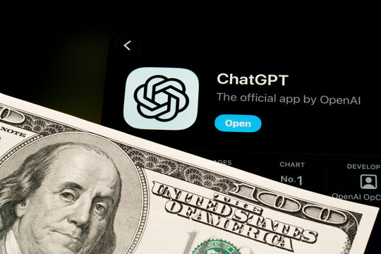 ChatGPT app on iPad showing Apple Liquid Glass redesign and iOS 26 App Store look beside US dollar banknote. Stafford, United Kingdom, April 13, 2026.