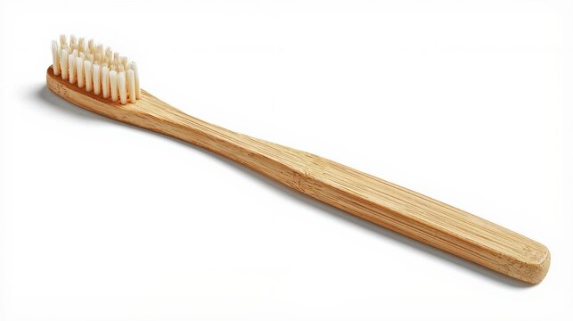 Bamboo toothbrush with light tan nylon bristles isolated on a white background
