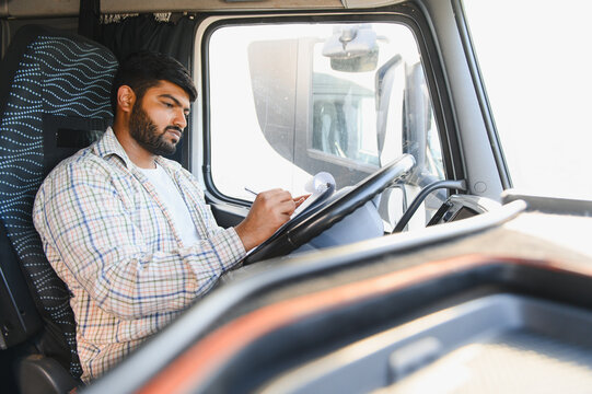 Indian truck driver documenting delivery details
