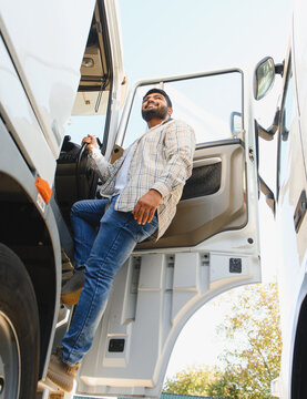 Indian truck driver smiling stepping into vehicle