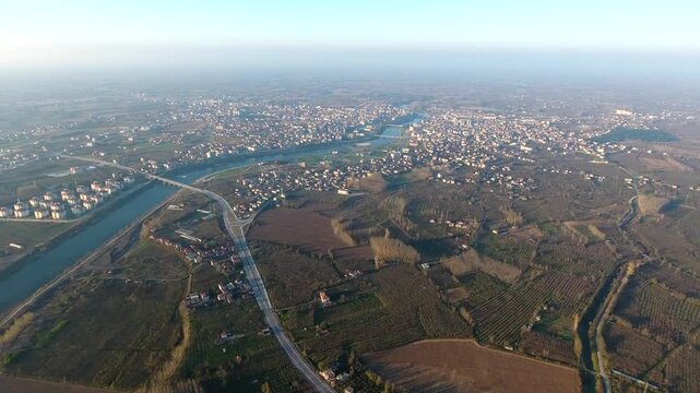 Panoramic aerial view of city and Kizilirmak watercourse crossing flat alluvial lowrelief zone in. Wide urban vista shows fluvial waters shaping settlement structure across central turkey.