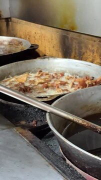 Making chicharr&oacute;nes, pork rinds in a kitchen 