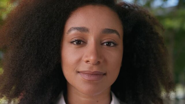 Confident young African American business woman close up face looking camera glad businesswoman female girl entrepreneur blinking staring ethnic lady expression portrait businessperson employee work