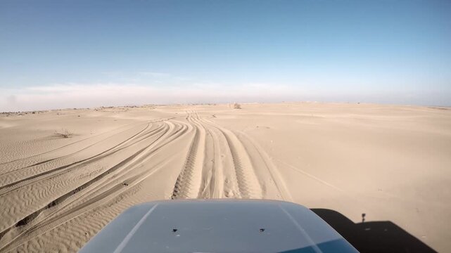 Desert vehicle stuck deep in soft sand as 4x4 offroad tracks vanish across a closed route. Bogged suv trapped on arid dunes remote overland travel failure impassable trail ahead.
