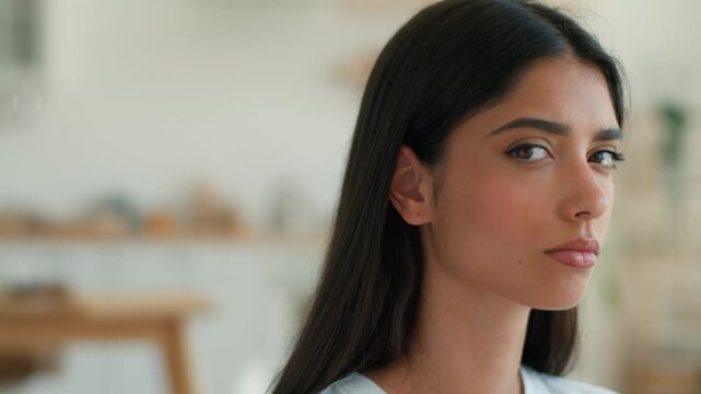 Sad frustrated Indian woman at home looking at camera upset stressed depression bad mood Arabian girl Latina female frown face anxiety breakup trouble health failure negative emotion crisis indoors
