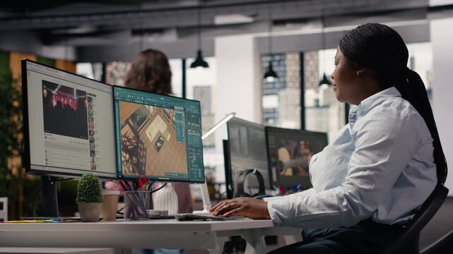 African american architectural developer working with remodeling software for apartment layout, interior design program on computer. 3D rendering on dual monitors in the office.