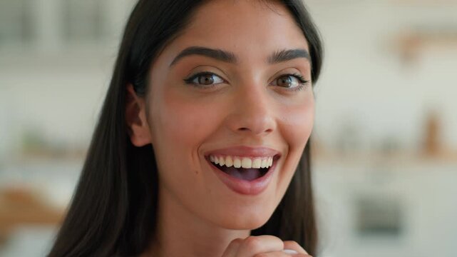 Surprised amazed Muslim Indian woman at home looking at camera shocked open mouth reaction good news success winning homeowner Arabian girl Islamic female client wife lucky celebration positive indoor