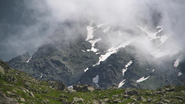 Panoramic Andes mountain peaks rise above clouds with rugged ridges and high altitude drama. Misty layers, vapor flow, elevated relief create striking atmospheric scenery across remote ranges.