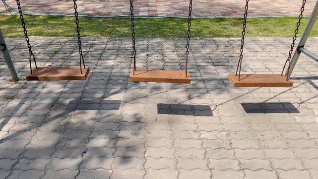 Wooden swing on the playground