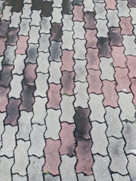 Close-up of Pile of worm block bricks prepared for pavement pattern texture background in the park at Thailand.