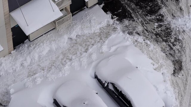 residential courtyard cars covered in snow winter snowfall top view aerial neighborhood parking snowed-in