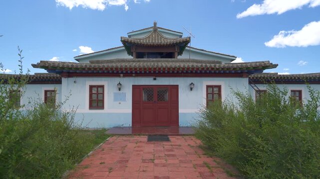 Ornate Buddhist temple roof with carved ridge tiles, colorful eaves, bright blue sky backdrop. Sacred shrine architecture shows traditional wood brackets, dragon finials, decorative rafters, sunlit.