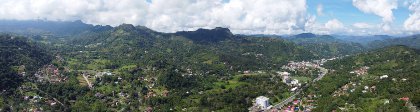 Panoramic aerial view from drone approaching la vega town in cundinamarca Colombia, Mountains arround blue sky