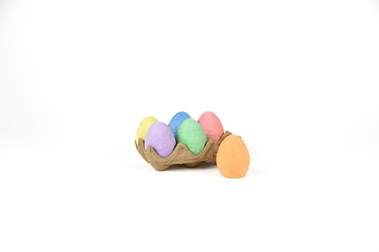 Easter basket stuffer of cardboard egg tray holding six brightly colored chalk Easter eggs 
