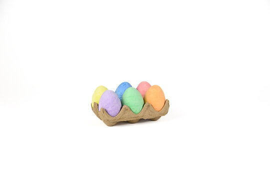 Easter basket stuffer of cardboard egg tray holding six brightly colored chalk Easter eggs 