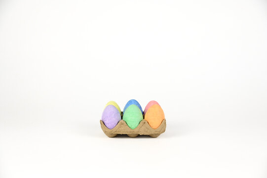 Easter basket stuffer of cardboard egg tray holding six brightly colored chalk Easter eggs 