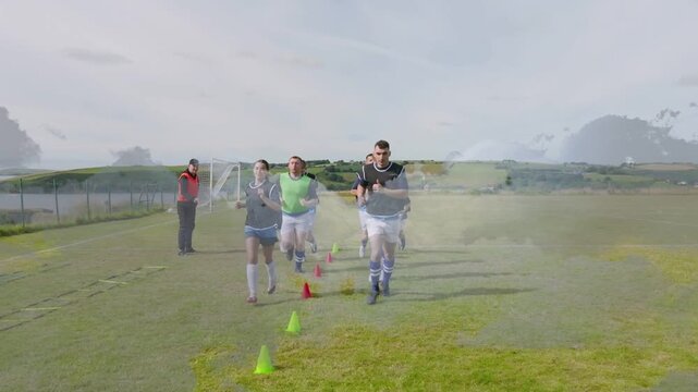 Group of soccer players are weaving through cones on grassy pitch in flat design, coach gesturing