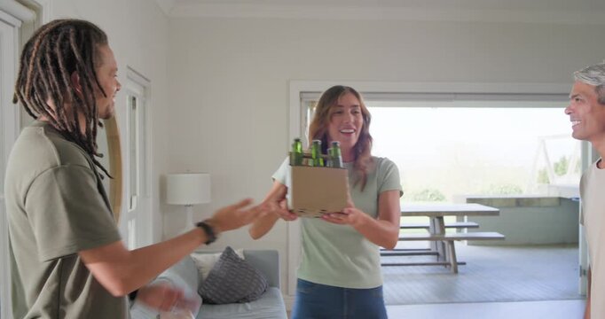 Diverse friends entering folding doors hugging handing sixpack placing on low table socializing