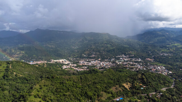 aerial, drones flying over a beautiful green mountains and villeta city in the Cundimarca region in Colombia. day 4K
