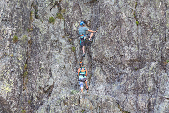 Chamonix-Mont-Blanc, Haute Savoie, France - August 09th, 2025: People climbing Les Gaillands rock, a traditional sporting activity maintained by the Compagnie des Guides de Chamonix.