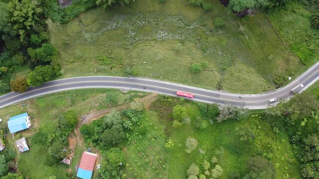 Top view drone shot road in mountains cars and motorcycle green area Cundinamamcar, Colombia. 4k