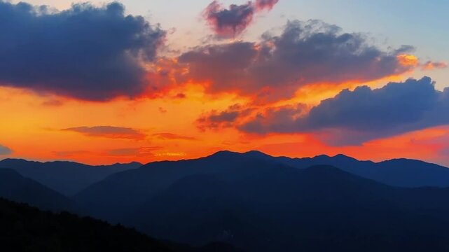 Clean and professional footage of a colorful sunset sky and mountain silhouettes, ideal for video backgrounds.
