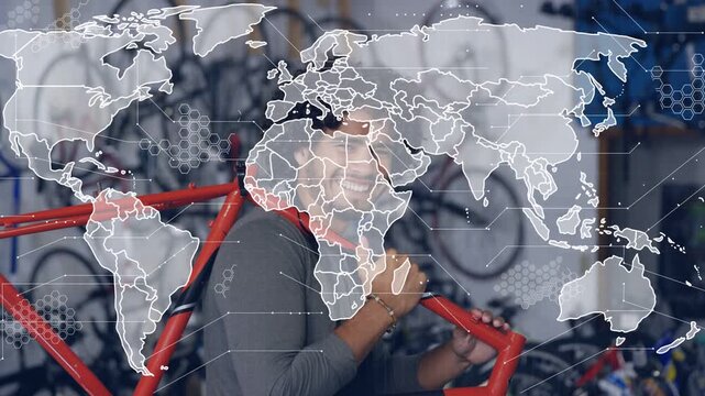 Bike tech lifting red frame, shouldering, inspecting for repair while world map hex overlay growing