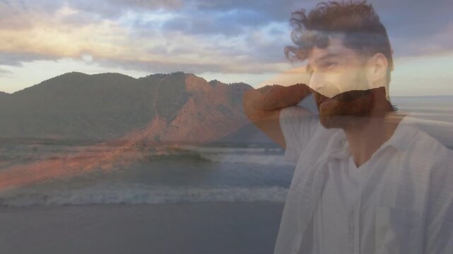 Mid adult man raising hand and turning to horizon while crossfade overlay appearing evoking travel