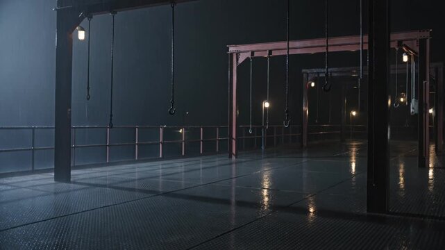 Empty Deck at Night With Hanging Hooks Sways in Crosswind and Rain Streaked Darkness