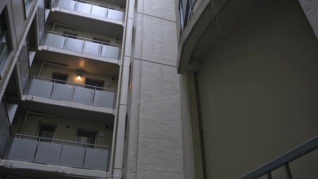 Empty Alley Behind Apartment Blocks Drips With Rain and Broken Windows in Urban Night Gloom