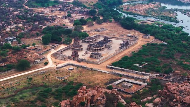 Shri Achyutaraya Swamy Temple with Tungabhadra river and greenery at vijayanagara, hampi, karnataka, india. day time, push in shot, drone shot, 4k.