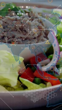 Vertical video: Low-angle pan showing salad bowl, HUD hex grid fading, tagging food for food tech