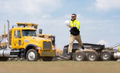 Happy construction builder. Worker jumping at heavy machines. Man engineer running to success. Builder man run to work. Engineer supervisor running outdoor. Supervisor jumping. Copy space © be free