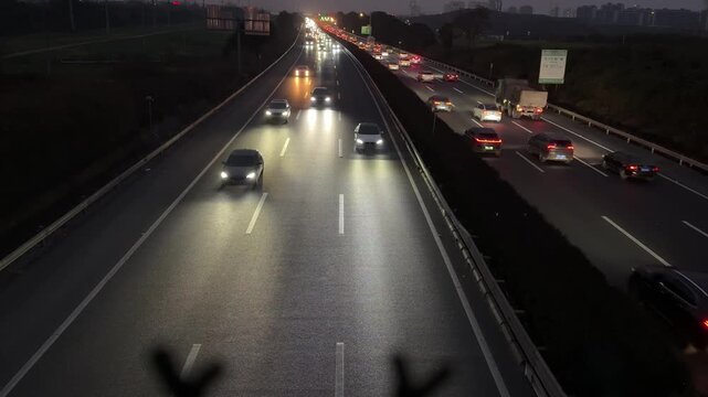 4K bird's-eye view of vibrant evening vehicle traffic flowing on a modern road in Chengdu, China.
