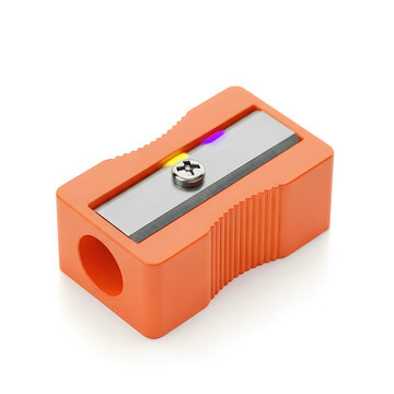 Orange plastic pencil sharpener with metal blade isolated on white background