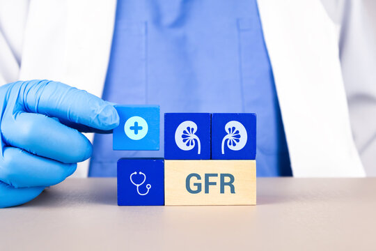 Concept of renal diagnosis, information on early detection and prevention of oncological pathologies. GFR. The nephrologist's hand arranges wooden cubes with kidney icons.