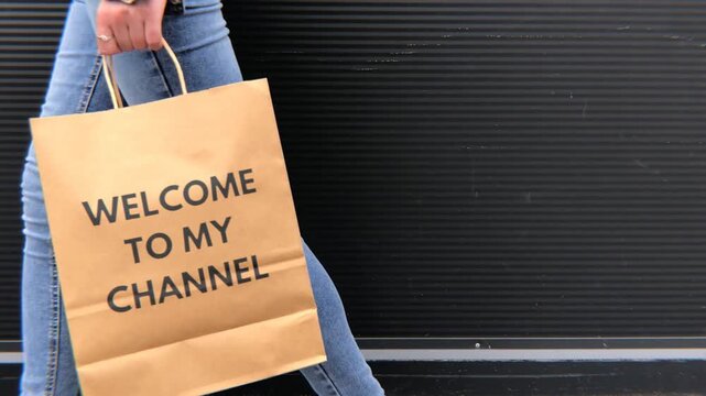 Welcome to my channel paper bag held social media content creator promotion
