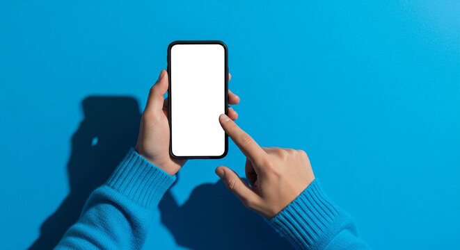 Overhead view of a person using a blank white smartphone screen on blue background perfect for digital network app mockups