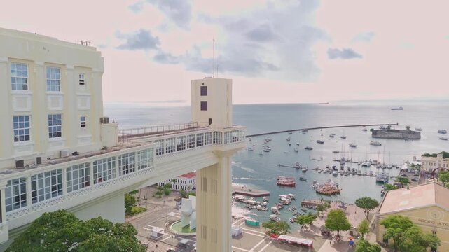 Urban landscape of Salvador, Bahia, featuring the Lacerda Elevator and the Mercado Modelo by the sea.