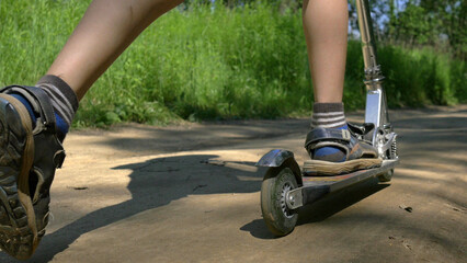 boy riding push scooter in the playground, have fun and enjoy © vla