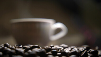 cup with hot coffee stands on coffee beans, have fun and enjoy © vla